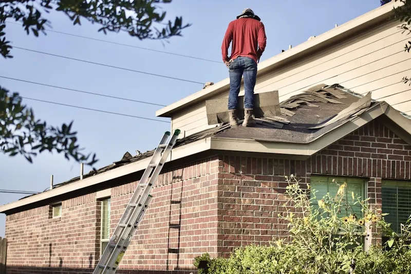 Professional roofer working on a residential roof in Four Oaks